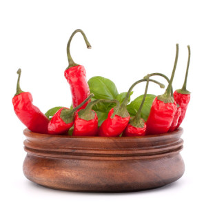 Hot red chili or chilli pepper in wooden bowl